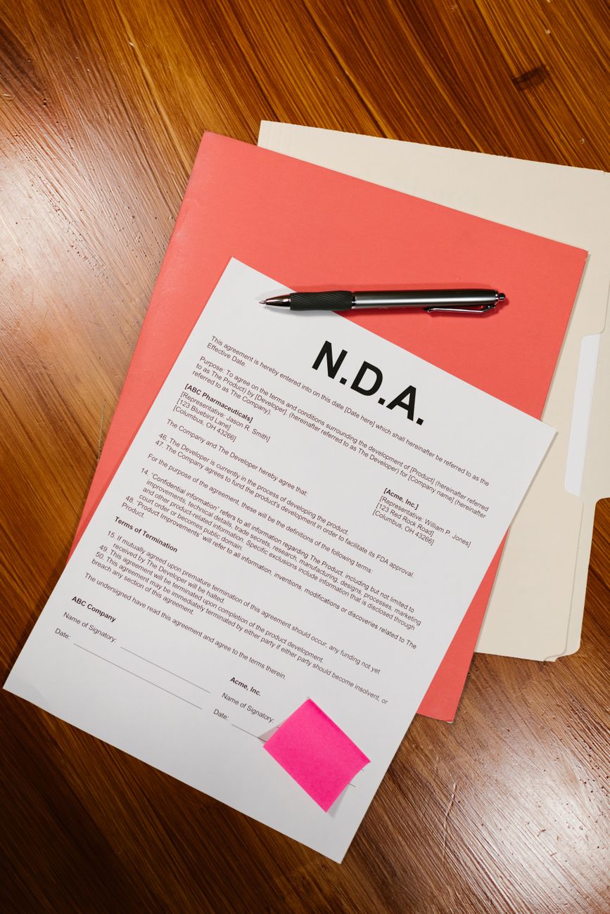 Confidential negotiation documents on wood table